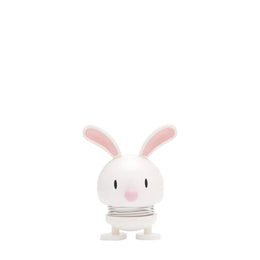 White rabbit-shaped object with pink ears on a white background