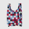 Checkered reusable bag with red, blue, and black pattern on a white background