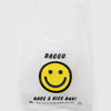 White reusable bag with a smiley face and 'BAGGU' branding on a white background