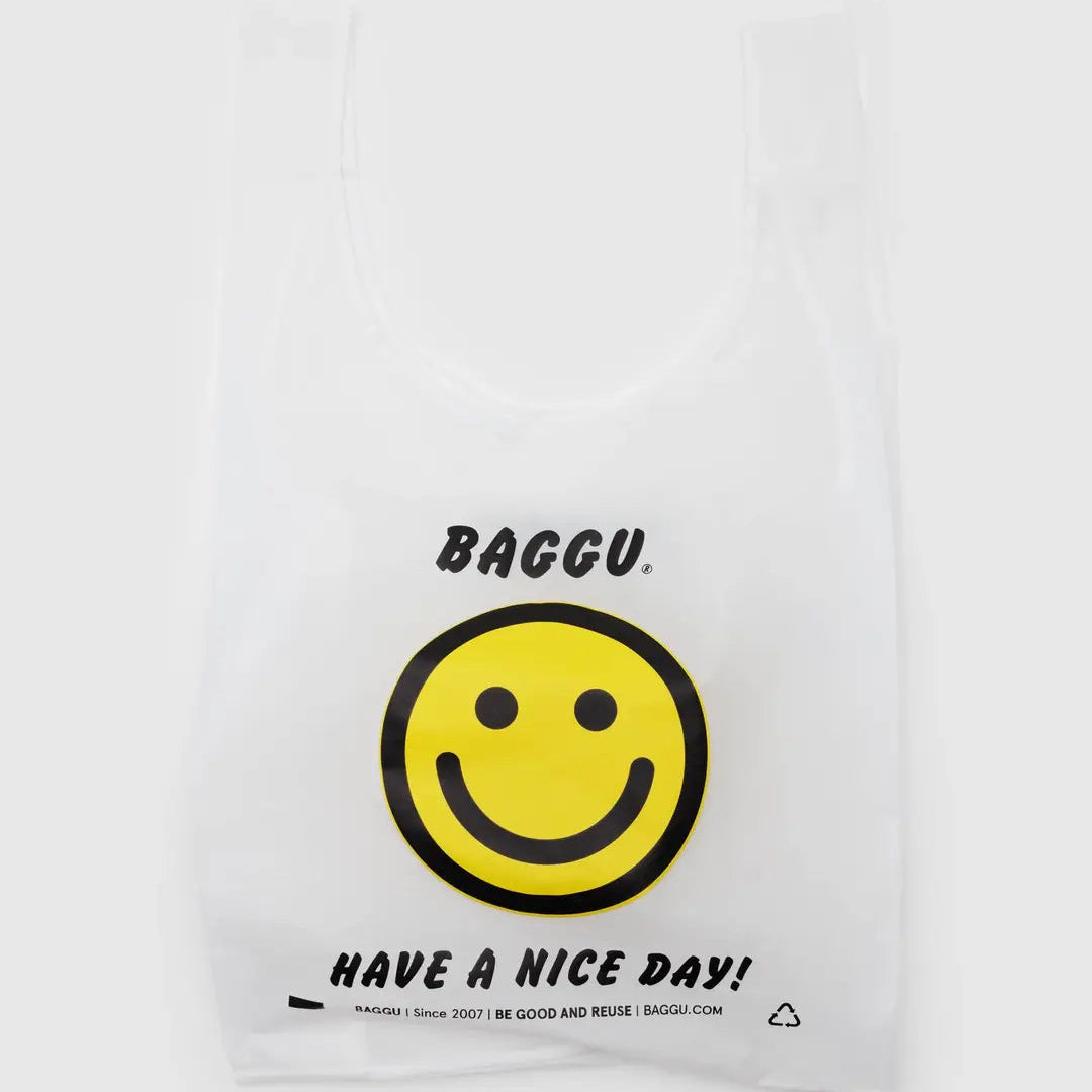 White reusable bag with a smiley face and 'BAGGU' branding on a white background
