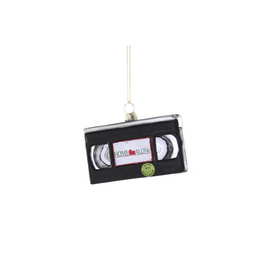 VHS tape ornament with 'Home Alone' label on a white background