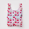 Reusable shopping bag with cherry pattern on a light pink background