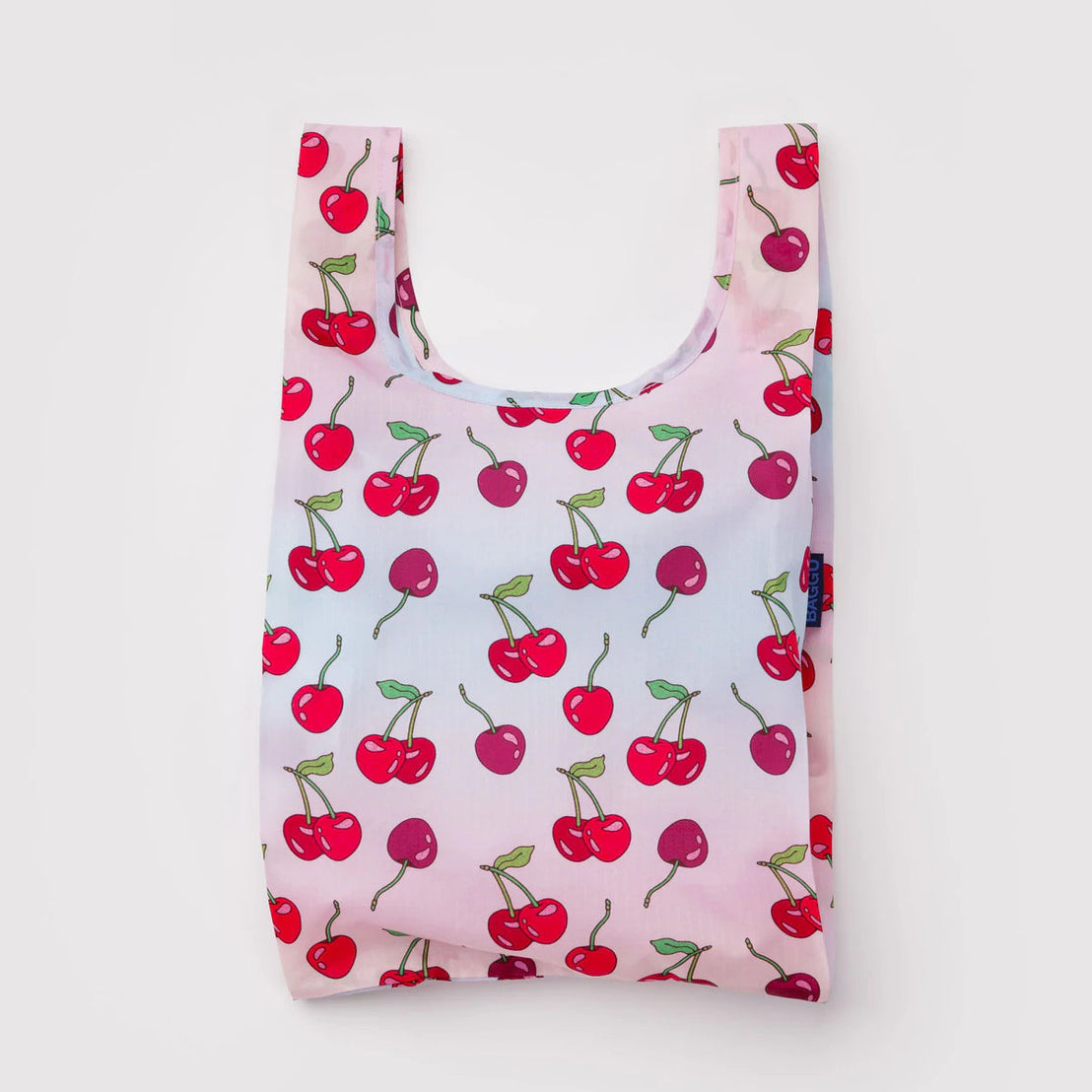 Reusable shopping bag with cherry pattern on a light pink background